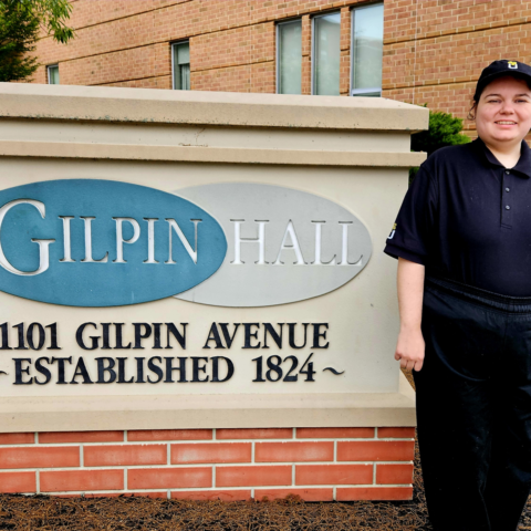 Emily standing in front of Gilpin Hall